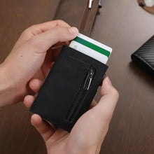 Load image into Gallery viewer, Person holding a black wallet with a card in it on a wooden surface
