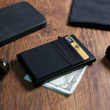 Load image into Gallery viewer, Black wallet with cards and money on a wooden surface