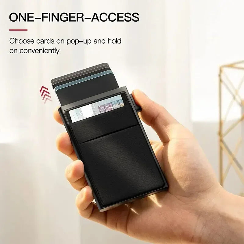 Hand holding a black cardholder with cards on a white background