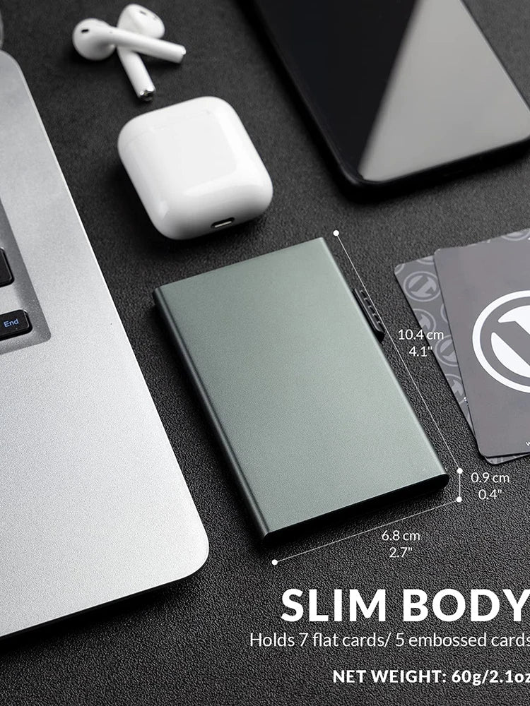 Ozerlo SlimPocket Wallet showing slim body dimensions with cards, laptop and wireless earbuds on a desk