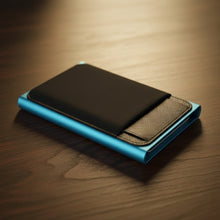 Load image into Gallery viewer, Blue and black wallet on a wooden surface