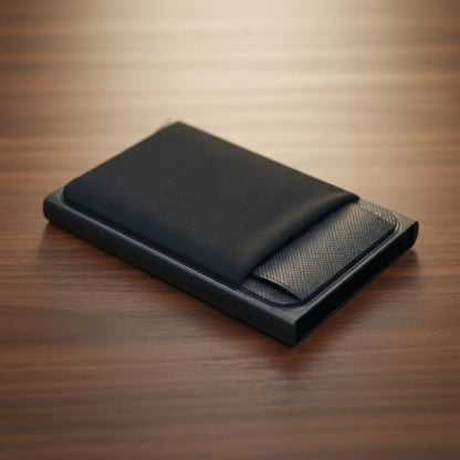 Black leather wallet on a wooden surface